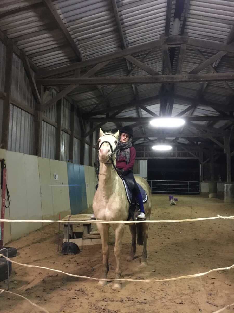 woman before paraplegic accident horseback riding on white horse