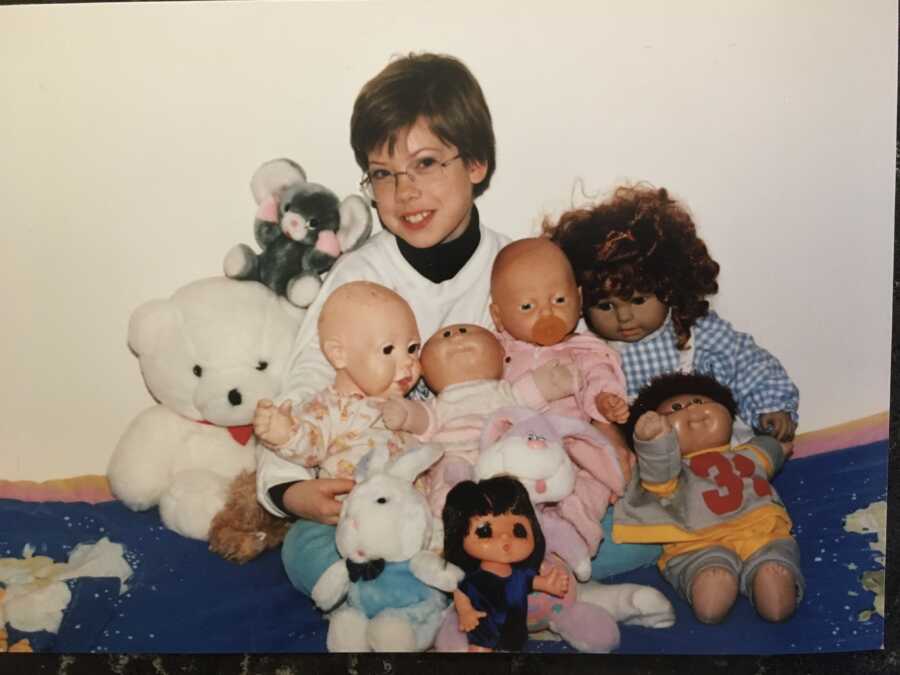 old photo of adoptive mom surrounded by baby dolls