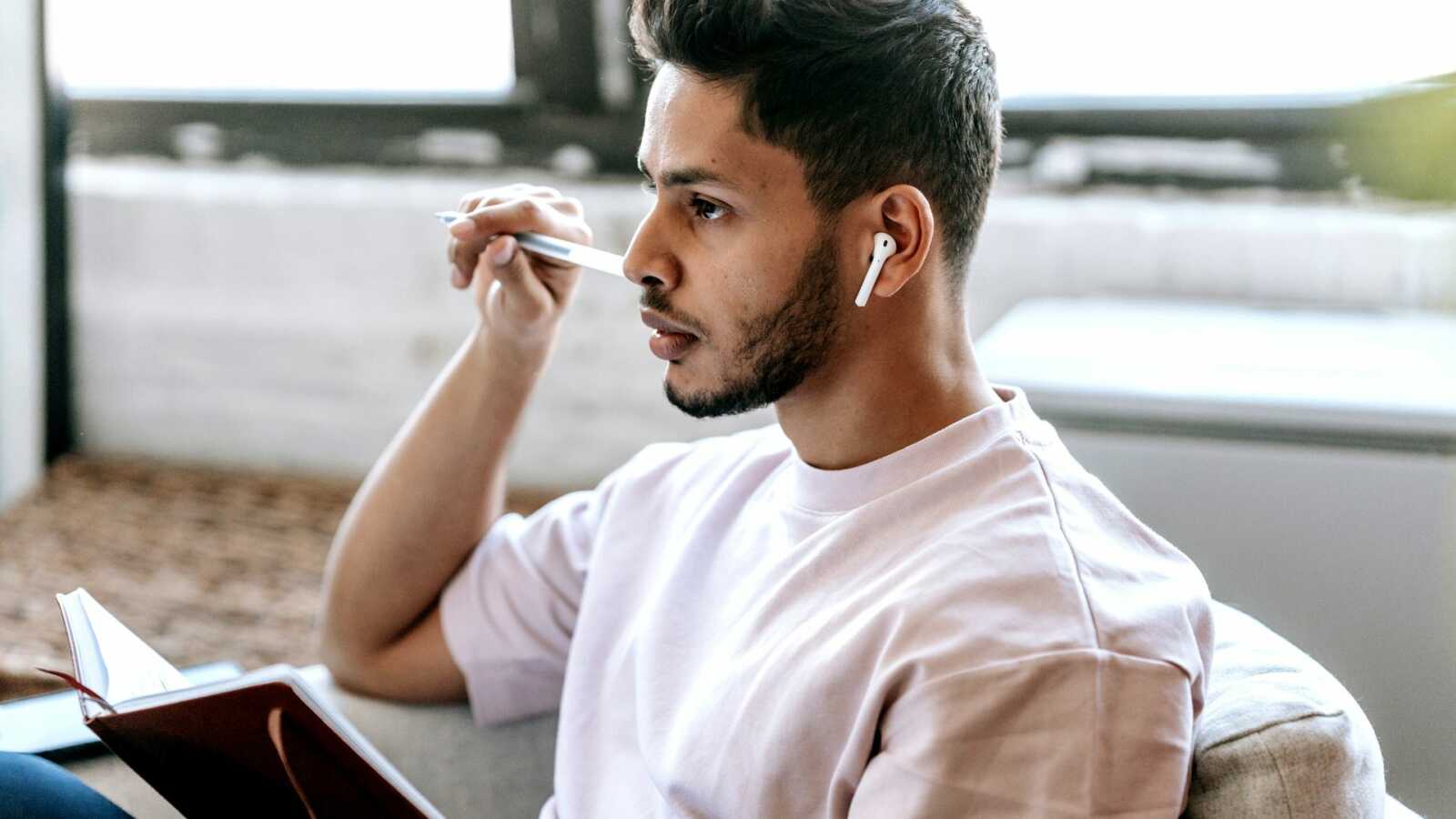 Man staring straight while holding book