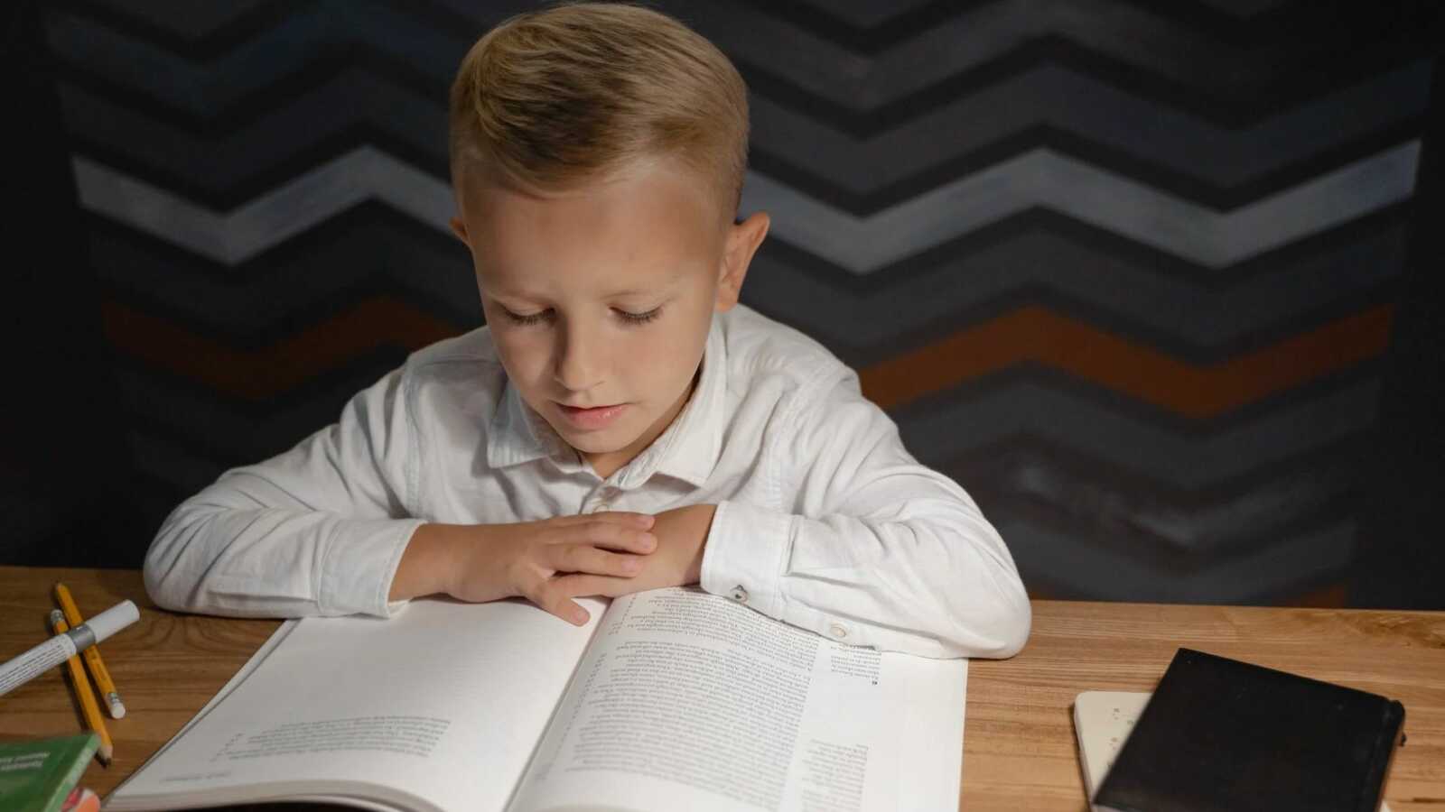 boy reading at a desk
