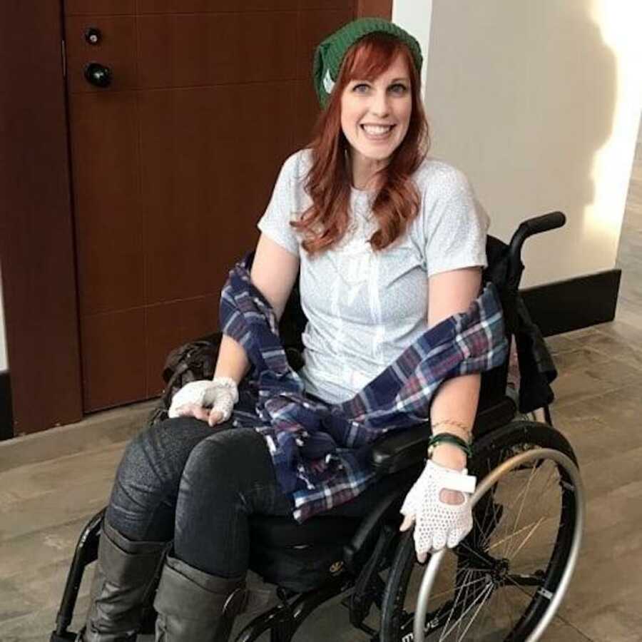 chronic illness warrior smiles while sitting in her wheel chair