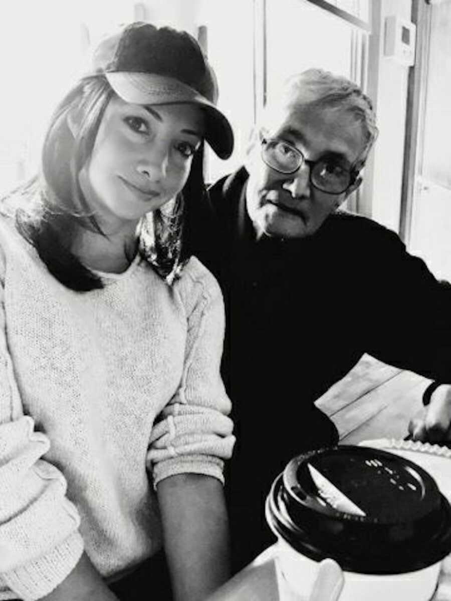 Daughter smiling next to father inside coffee shop