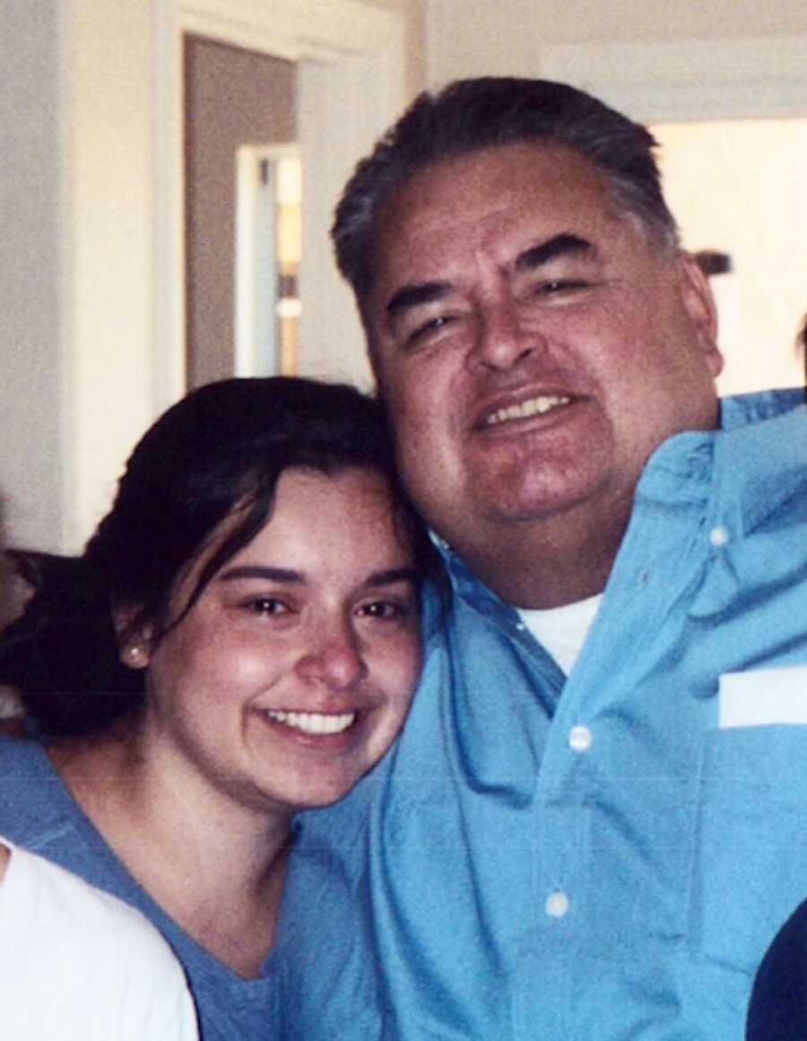 daughter stands with her father smiling