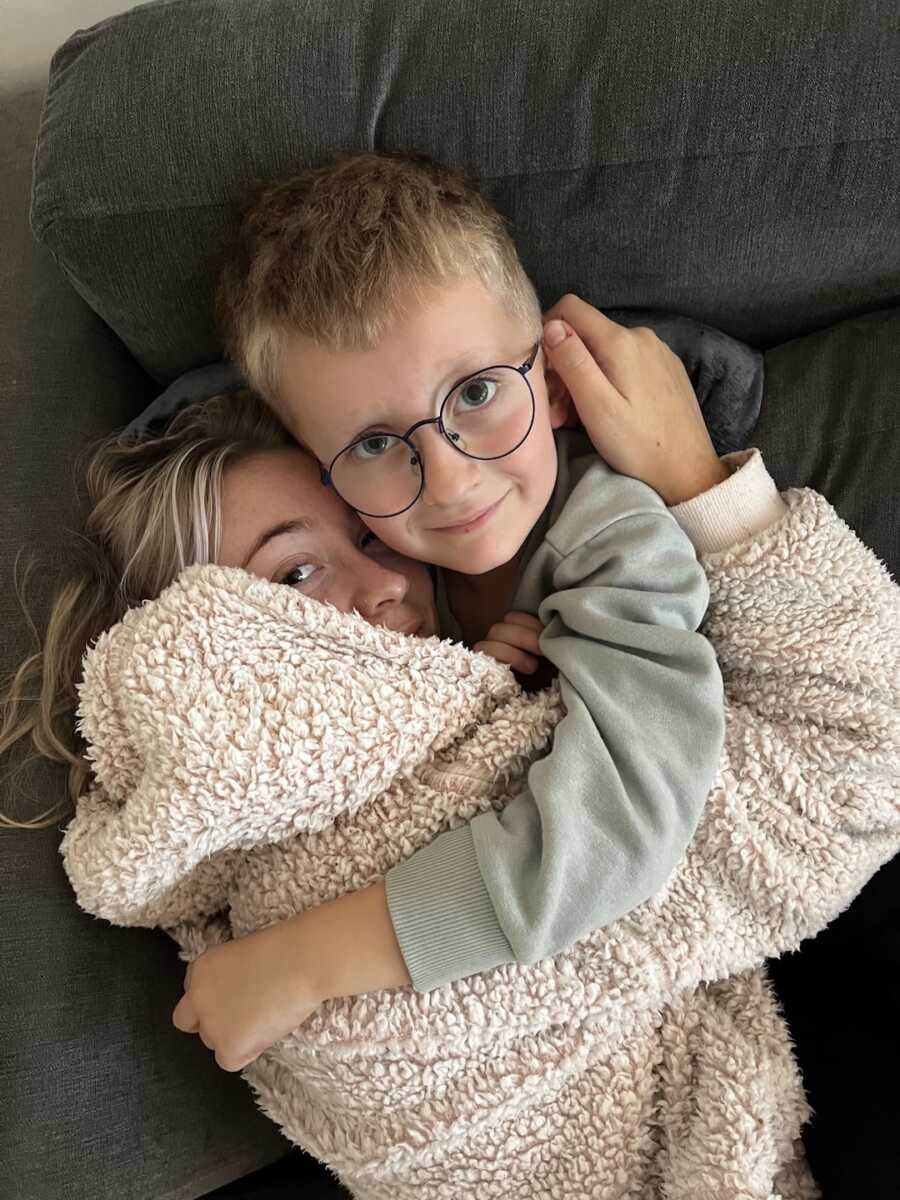 endometriosis warrior embraces her son in her arms