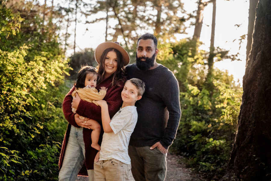 single mother stands with her children and their stepfather