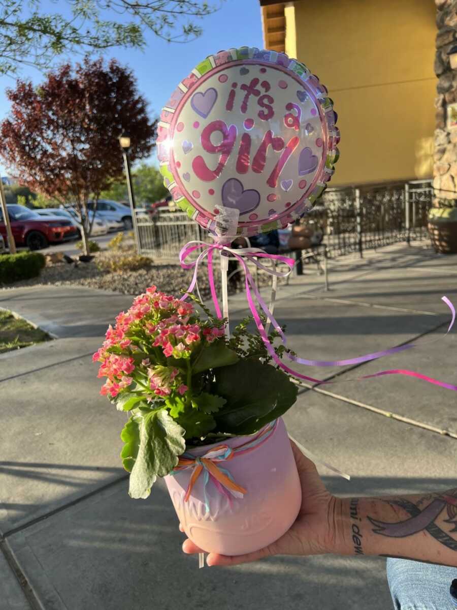 flower pot with it's a girl balloon
