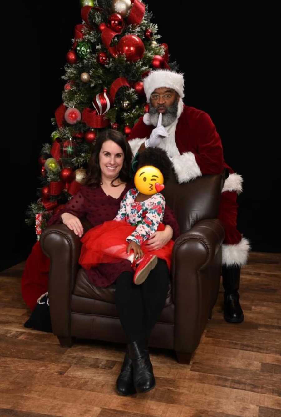 foster mom sits with her foster daughter with black santa