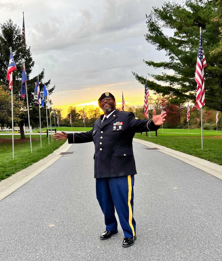 army veteran that is now a pastor in dress blues by United States flags
