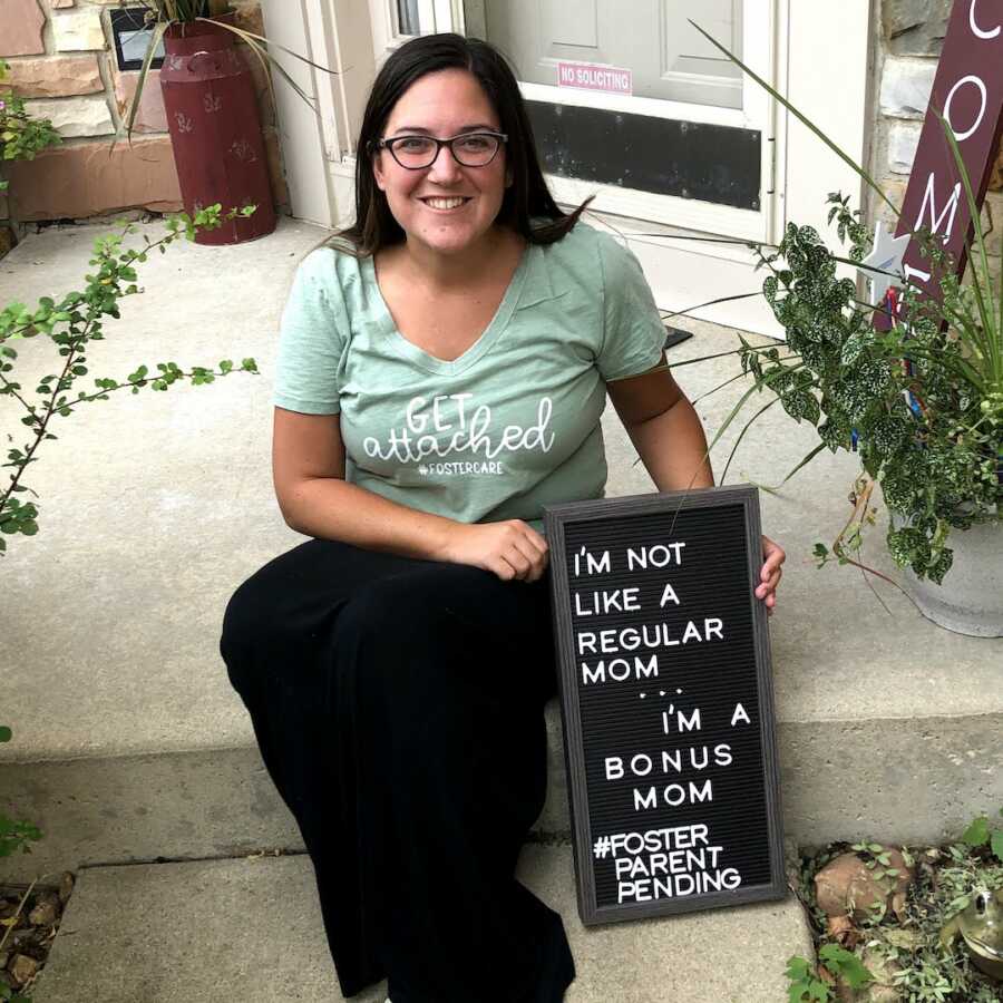 woman sitting on steps announcing she is going to be a single foster mom