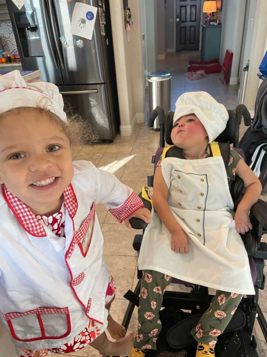 sisters dressed up as chefs with one being special needs and quadriplegic