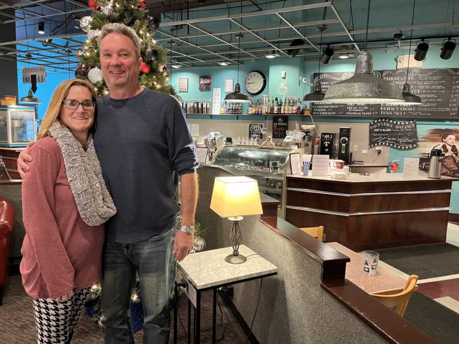 Small business couple standing in their restaurant 