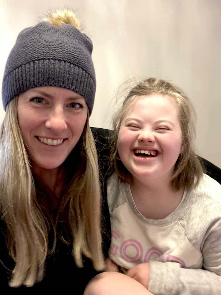 mom next to her daughter with special needs, both are smiling