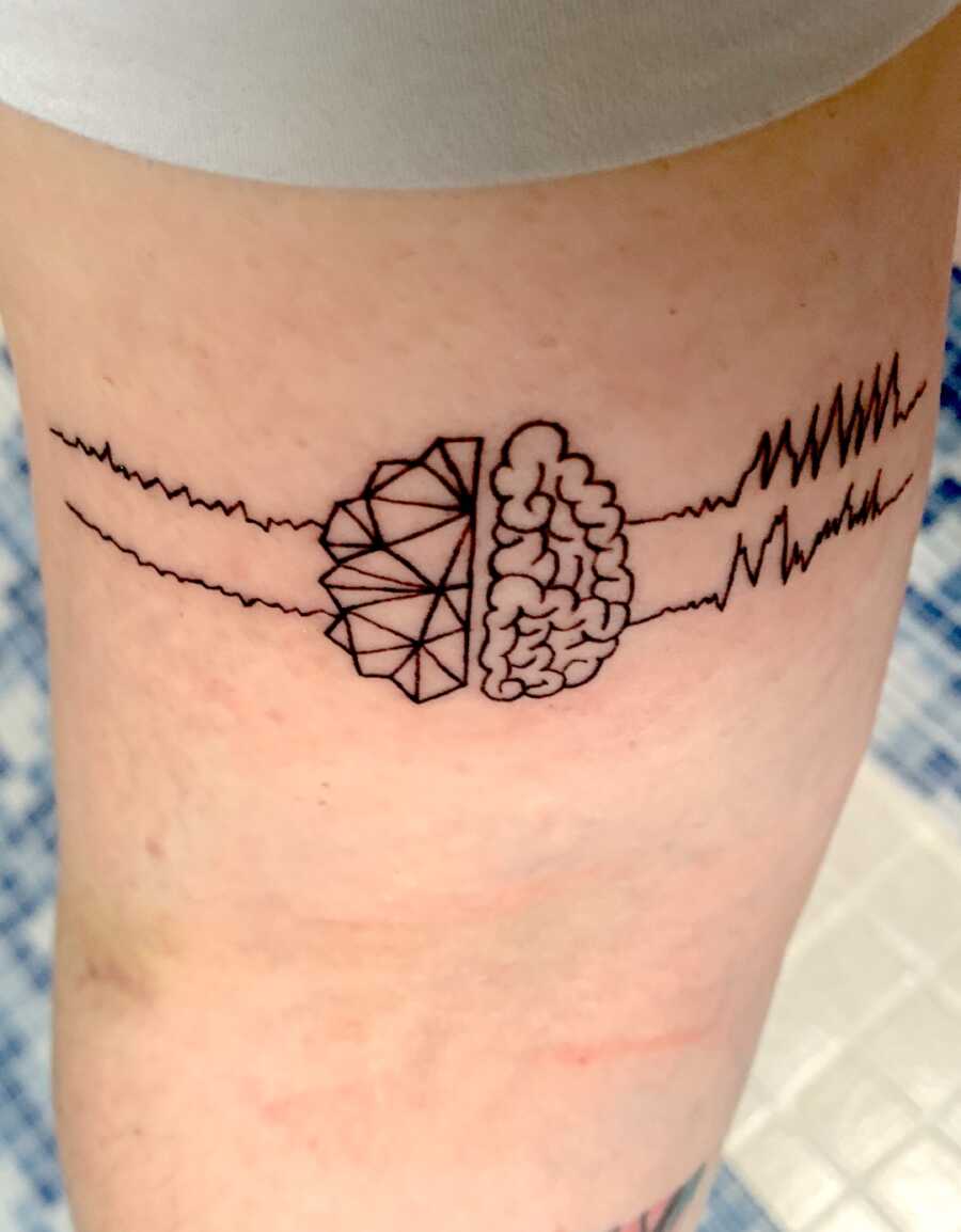 tattoo on woman with epilepsy of brainwaves and brain for epilepsy awareness