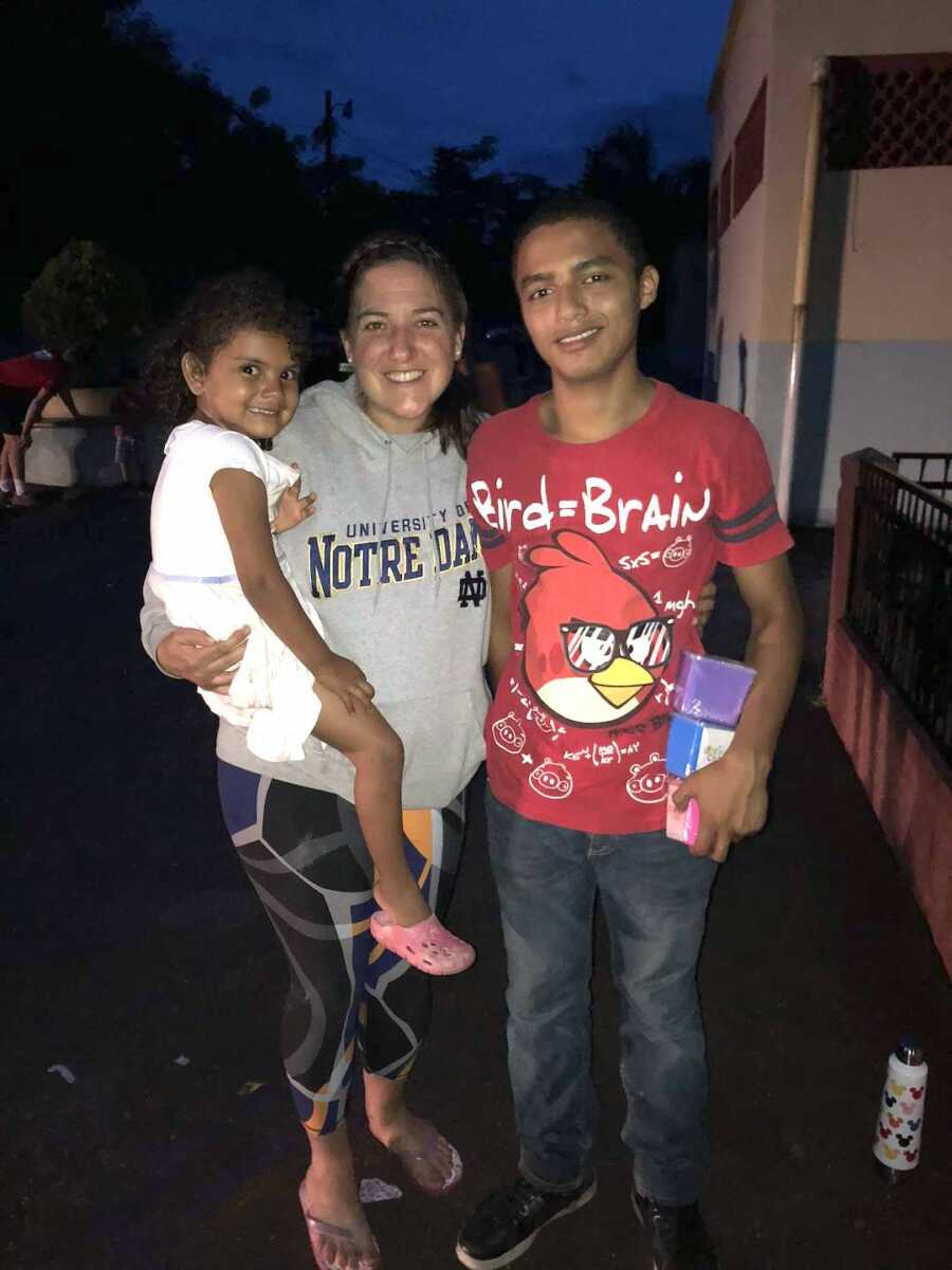 teacher with two children she met while teaching in Honduras