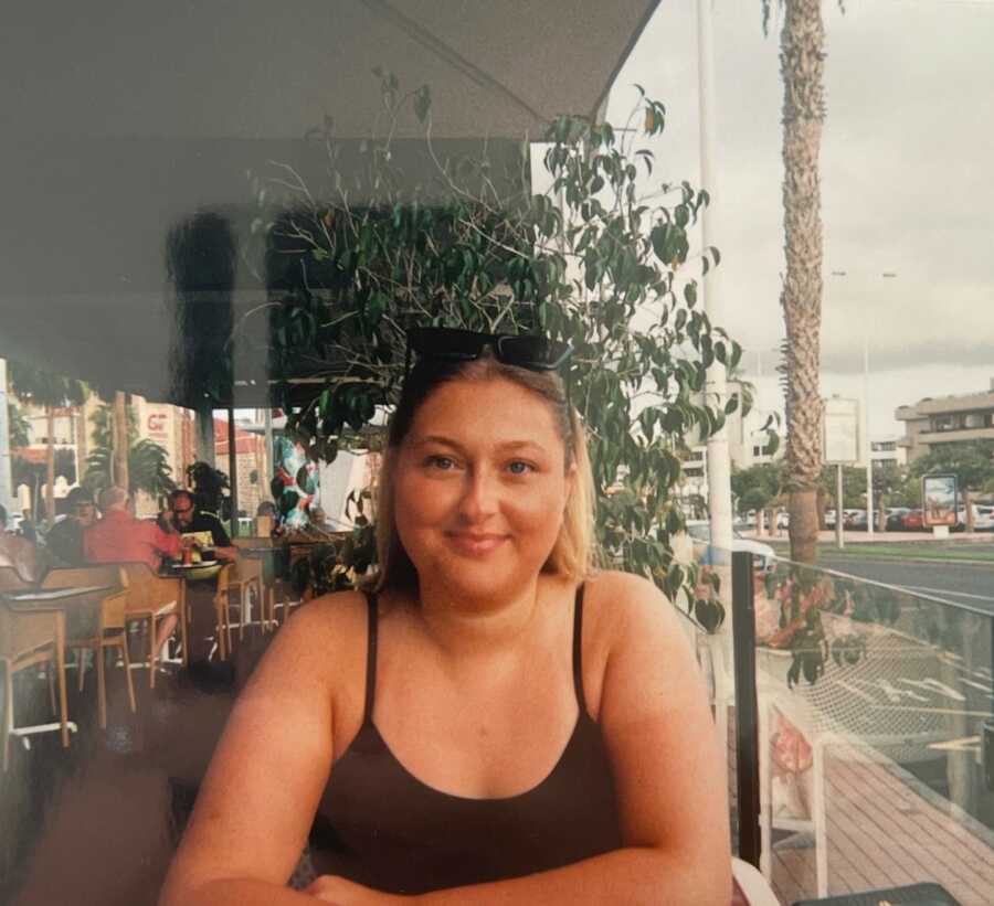 woman with chronic fatigue syndrome at a restaurant seated outside