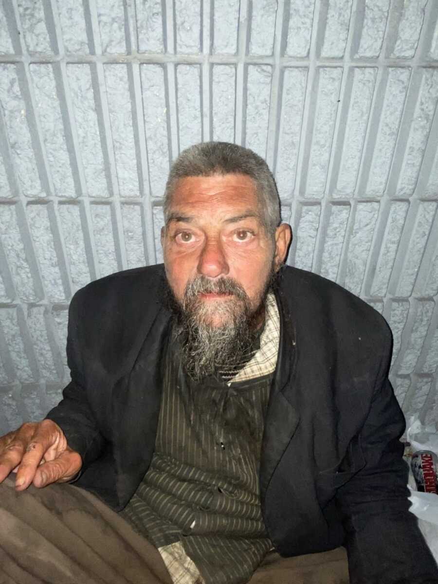 Homeless man with new haircut staring into camera lens