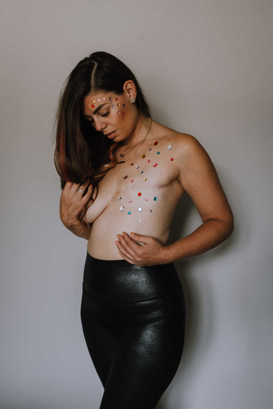 Mastectomy scar covered in colorful stick-on gems