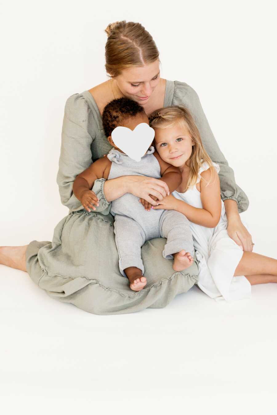 Mom sits with her daughter and foster son