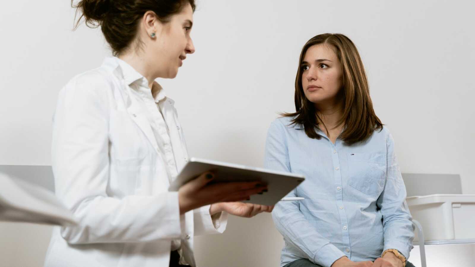 pregnant woman talking to doctor